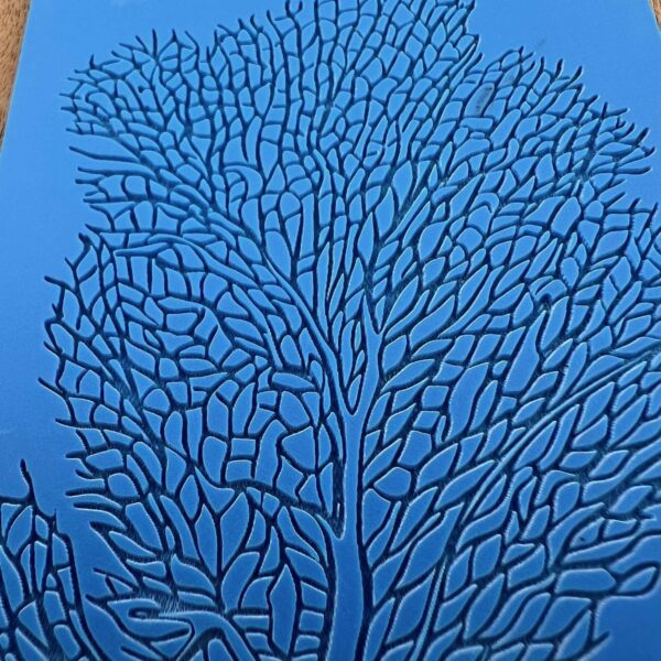 Intricate blue coral pattern resembling a tree structure.