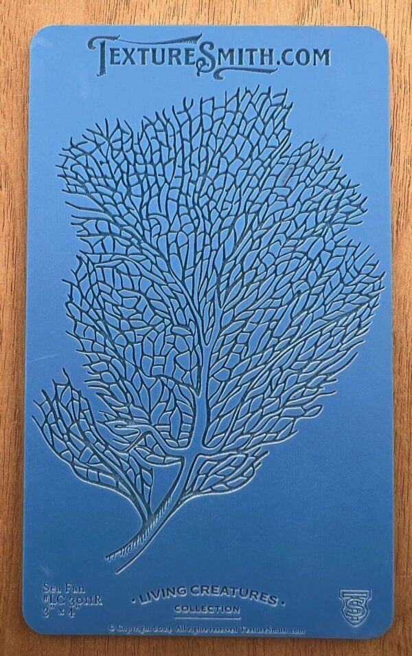 Intricate coral pattern embossed on a blue surface.
