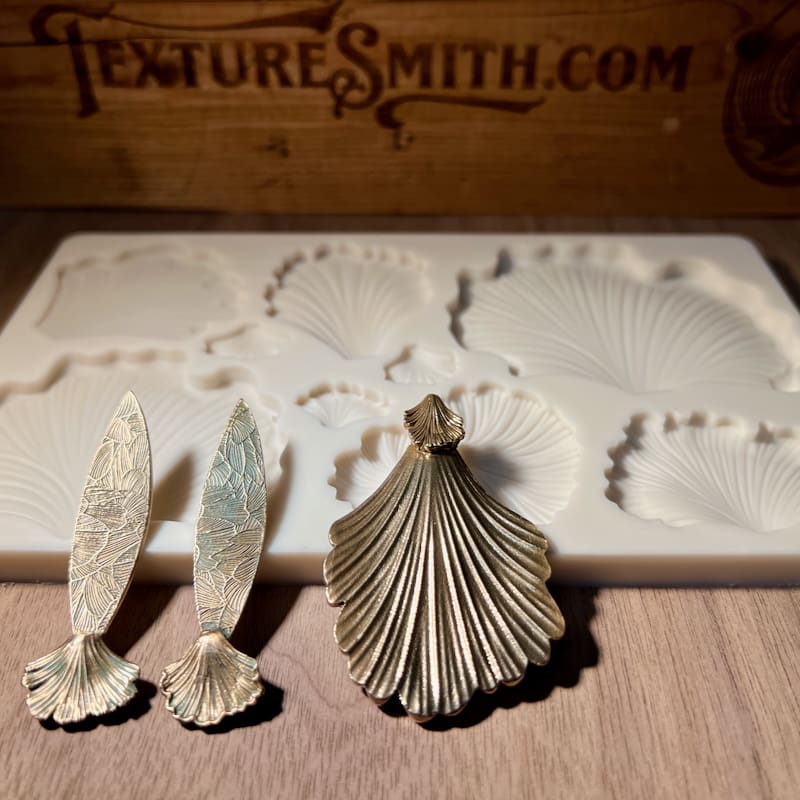 Three detailed resin molds for crafting sea-themed decorations.