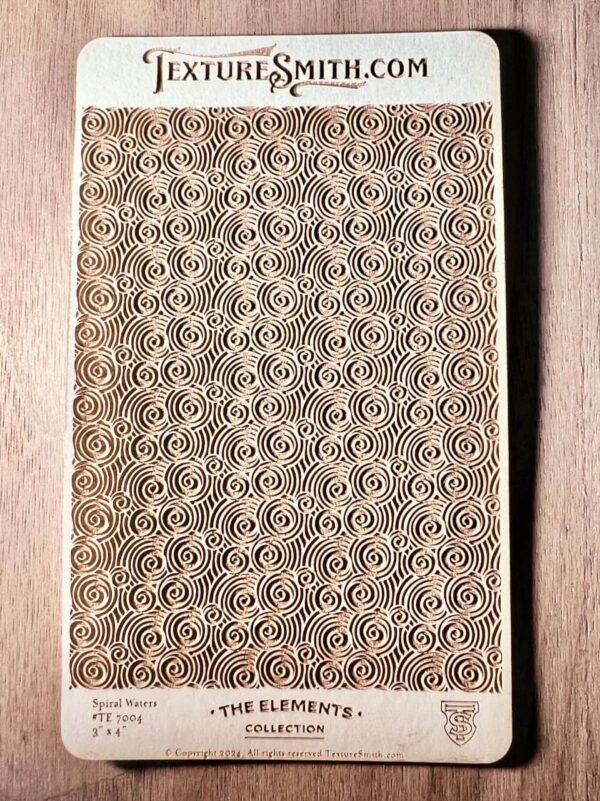 Intricate rectangular mat with repeating geometric patterns on a wooden surface.
