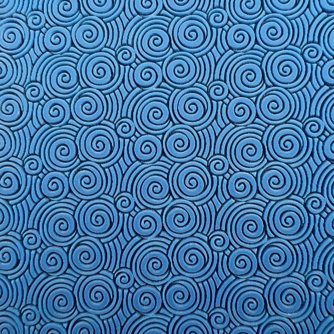 Blue fabric with intricate spiral patterns.