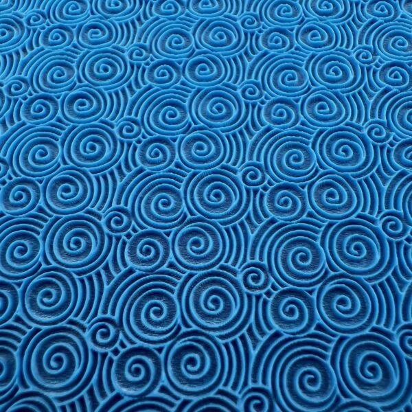 Blue fabric with black spiral patterns.