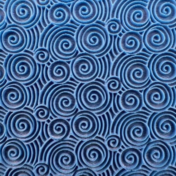 Blue fabric with intricate black spiral patterns.