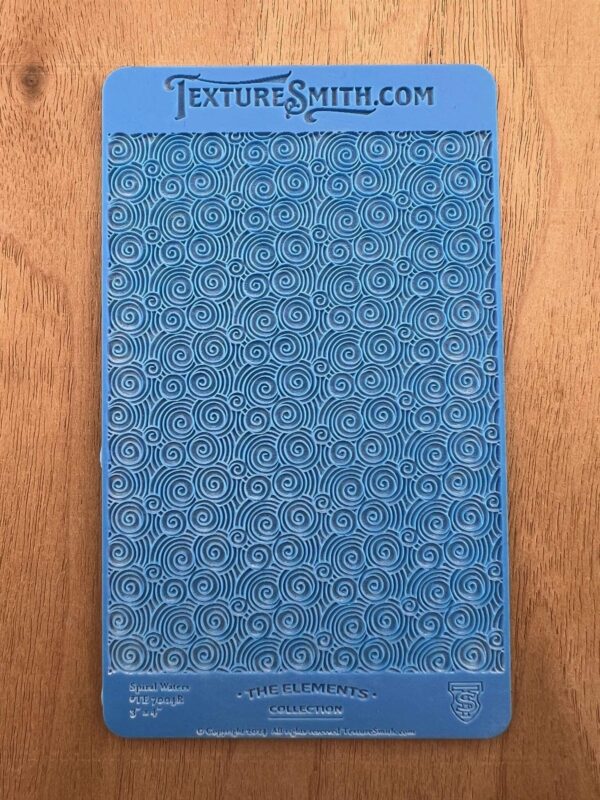 Blue plastic sheet with embossed patterns, labeled John Hancock.