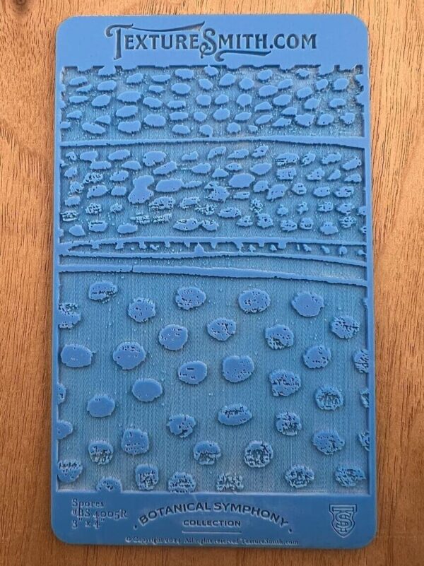 Close-up of a blue textured mat with various raised patterns.