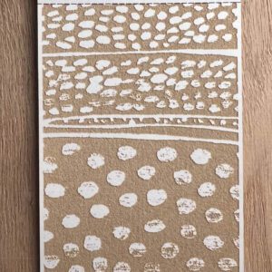 Abstract painting with white dots and lines on a brown background.