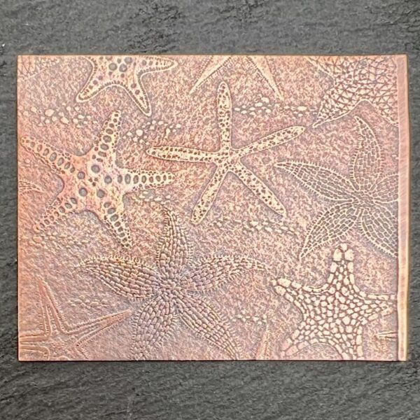 Intricate textured artwork with starfish motifs on a beige canvas.