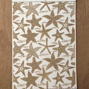 Decorative fabric with starfish pattern in shades of brown and beige.
