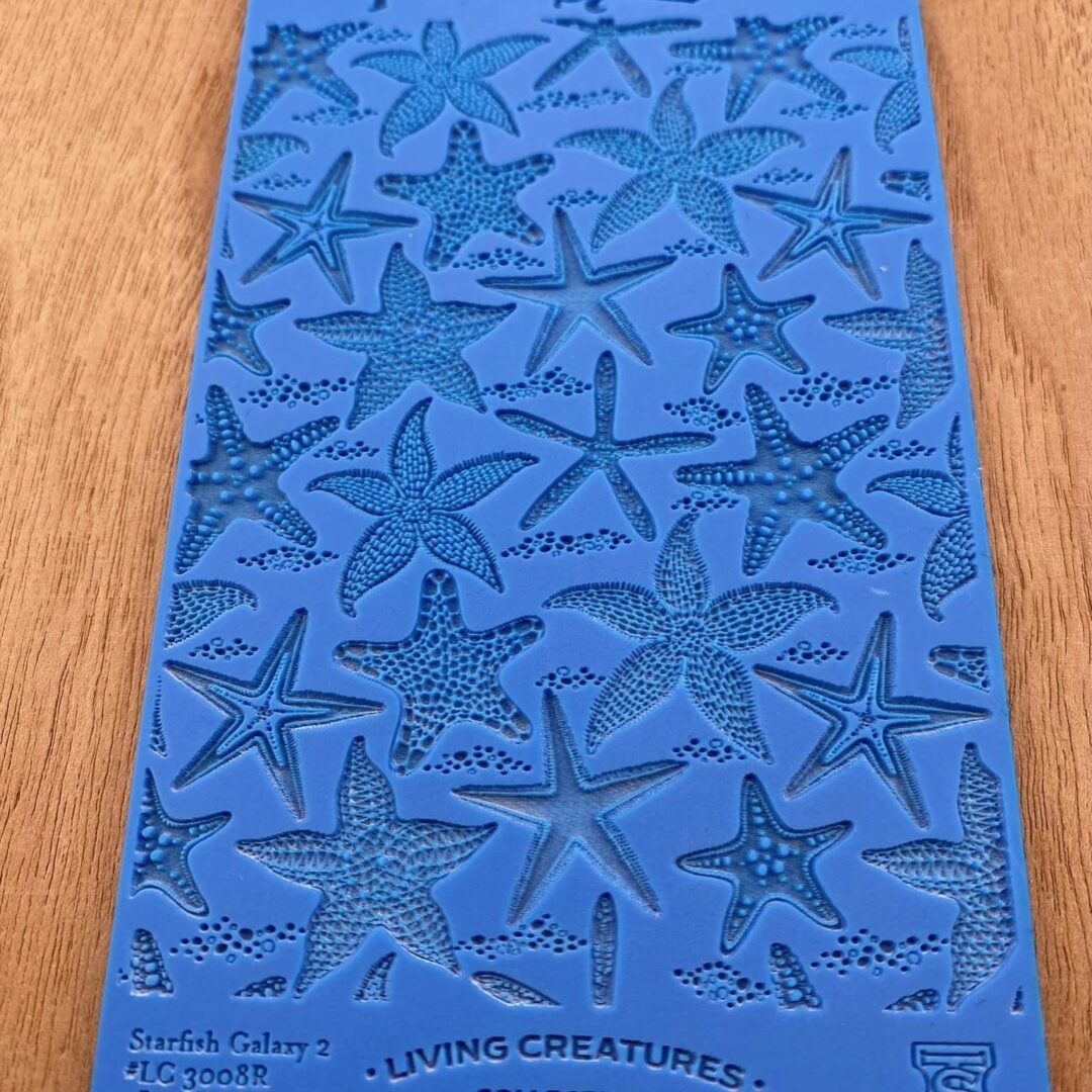 Blue textured sheet with starfish patterns.