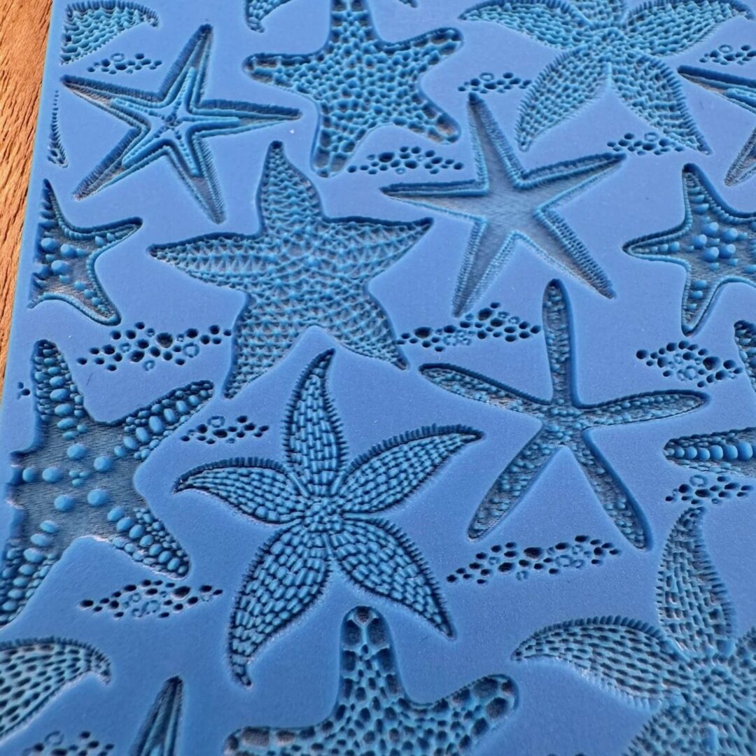 Blue silicone mold with various starfish shapes for crafting or baking.
