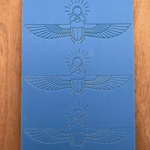 Blue card with three embossed Egyptian scarab designs.