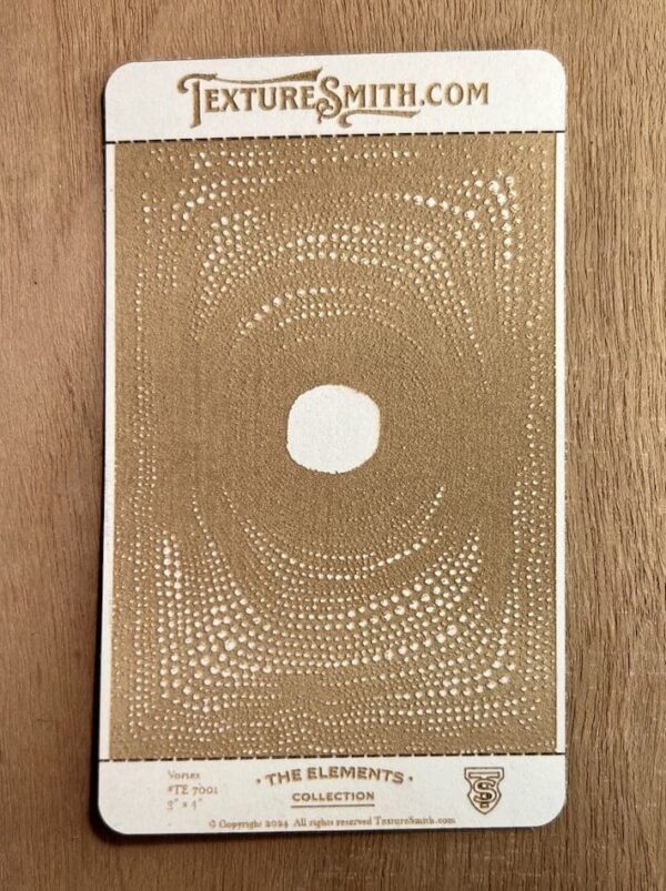 Abstract artwork featuring a central white circle surrounded by intricate, swirling gold patterns on a beige background.