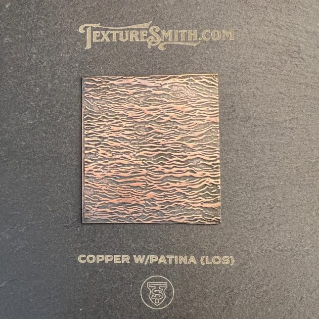 Textured copper sheet with patina finish.