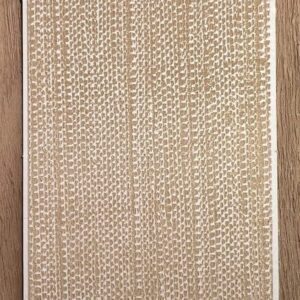 Close-up of a textured beige woven rug on a wooden floor.