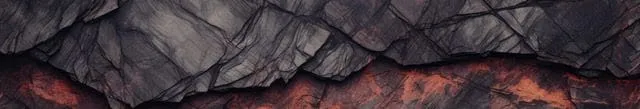 Close-up of textured rock layers with dark and reddish hues.