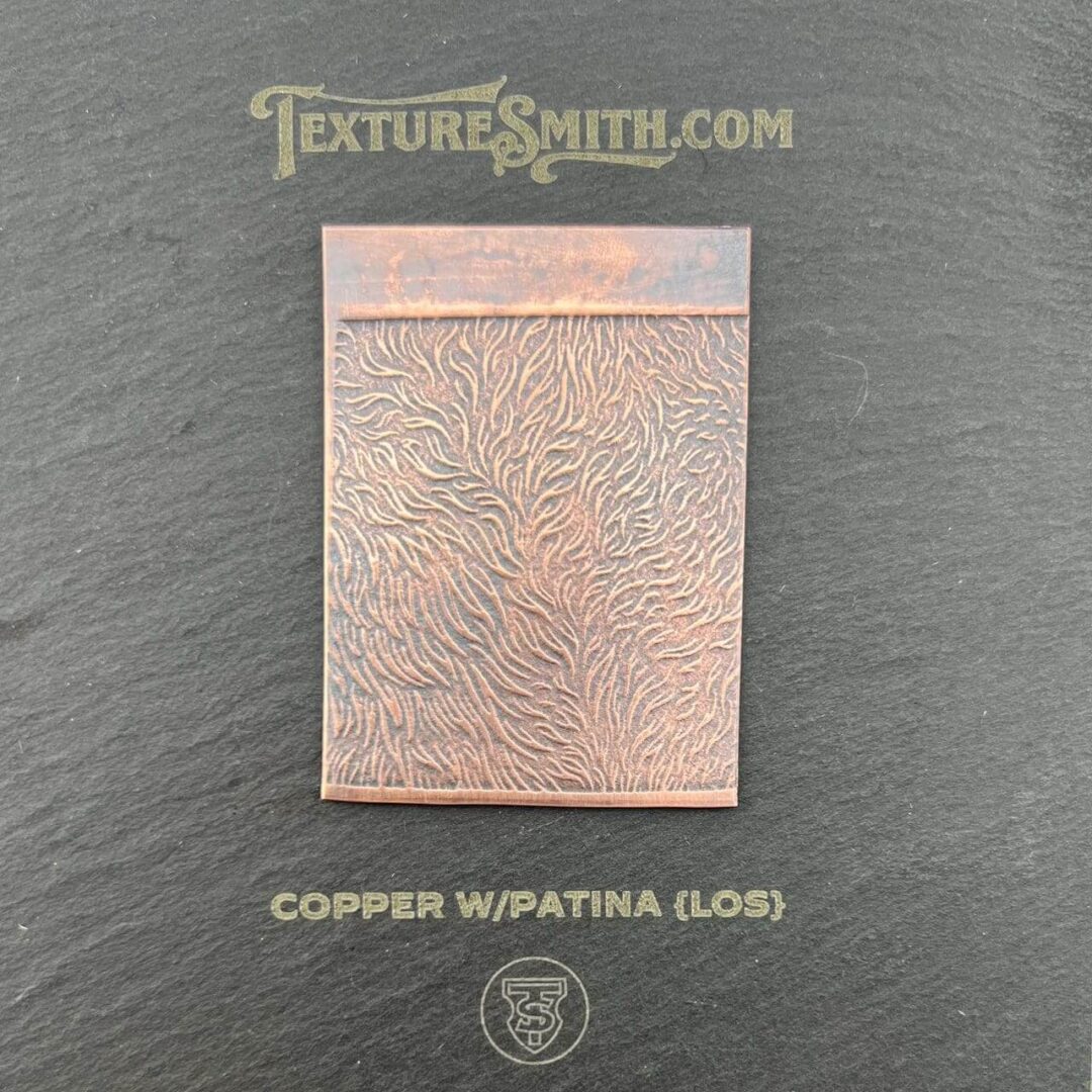 Copper sheet with intricate wapatina patina design.