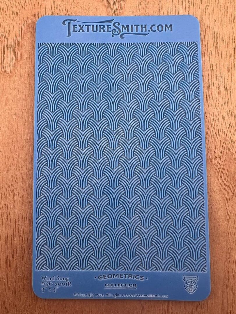 A blue textured book cover with a repeating geometric pattern.