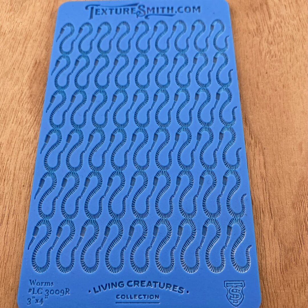 Blue card with repeating question mark patterns and some text at the top and bottom.