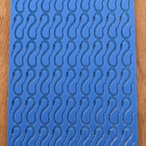Blue sheet with repeated footprint patterns on a wooden surface.