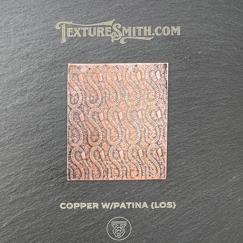 Copper sweating slab with intricate textured patterns.