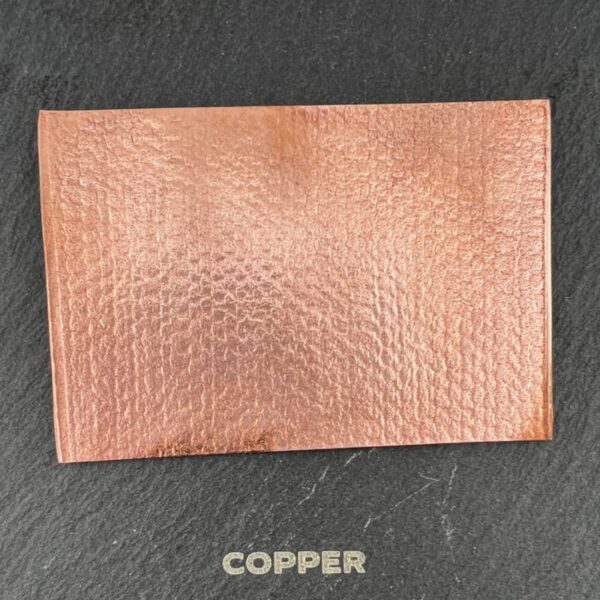 Copper-colored textured wallet on a dark surface.