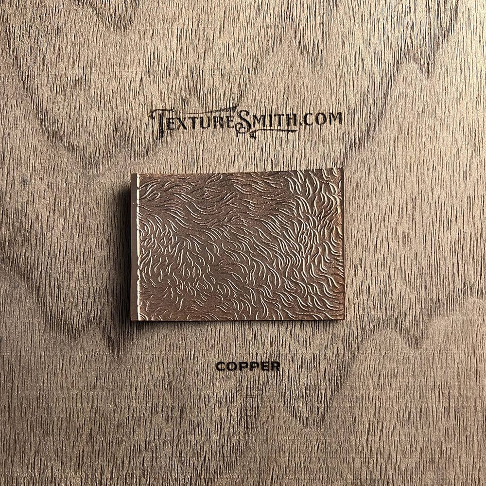 Close-up of a textured brown leather wallet on a wooden surface.