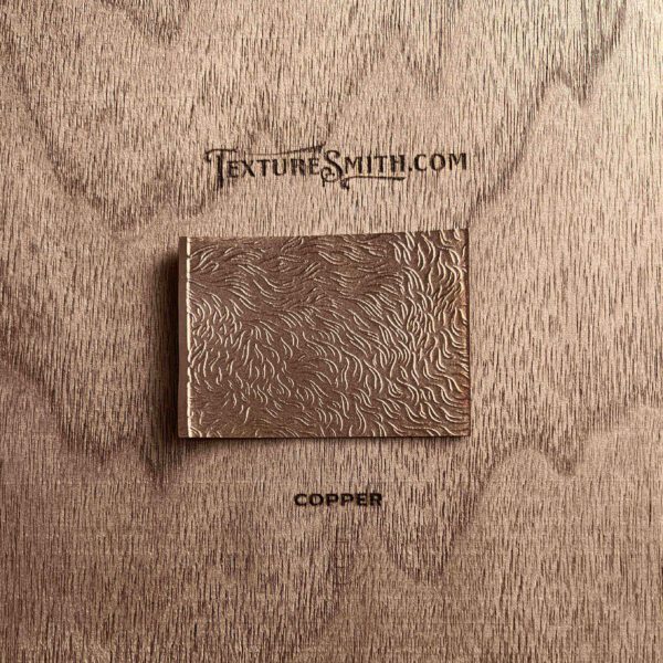 A textured brown wallet on a wooden surface with a logo.