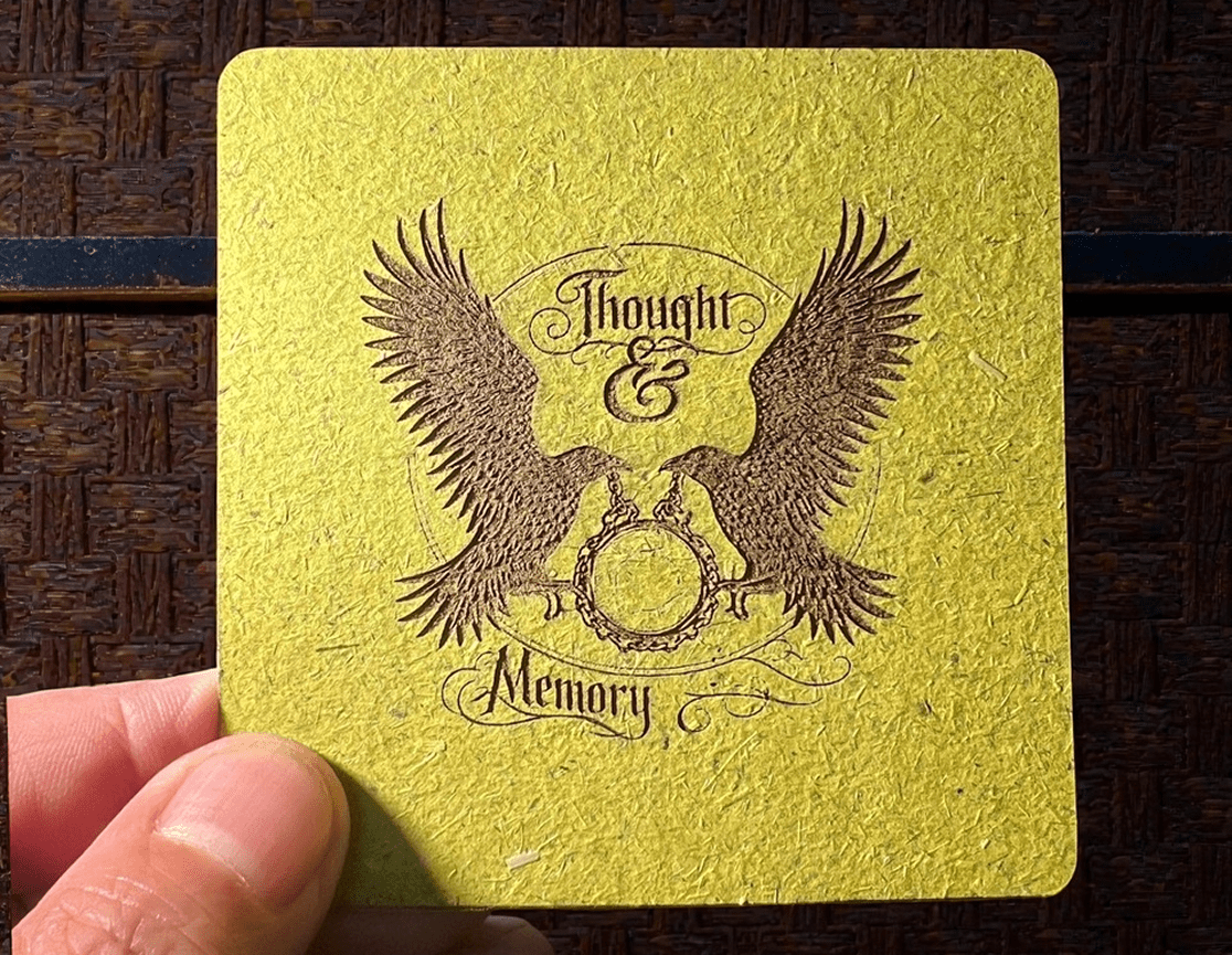 Vintage-style coaster with eagle and ornate text design.