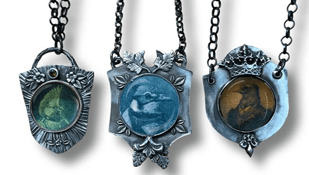 Three ornate pendants with circular images and chain links.