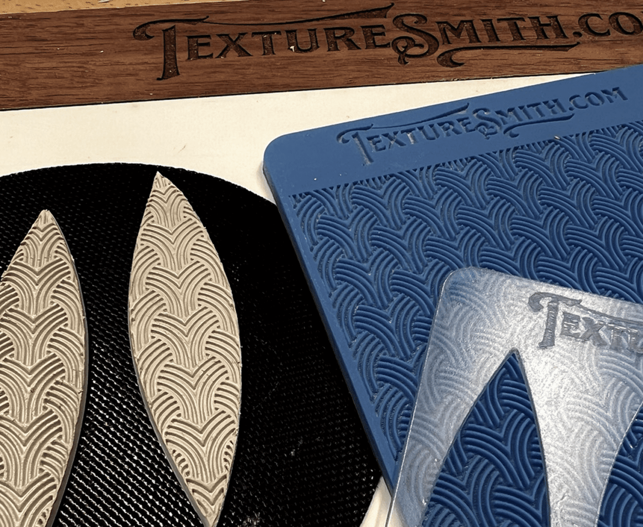 Leatherworking tools with intricate texture patterns and stencils.