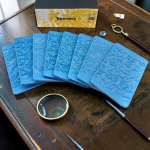 Blue embossed cards fanned on wooden table
