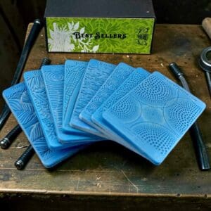 Blue textured embossing plates on wooden table