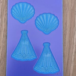 Purple silicone mold with seashell and dress shapes