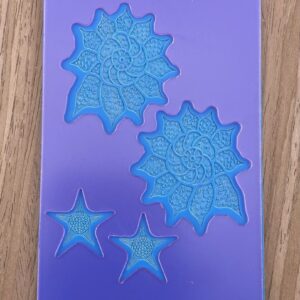 Purple silicone mold with swirl and star shapes