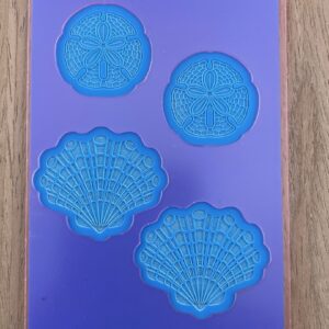 Purple silicone mold with shell and sand dollars