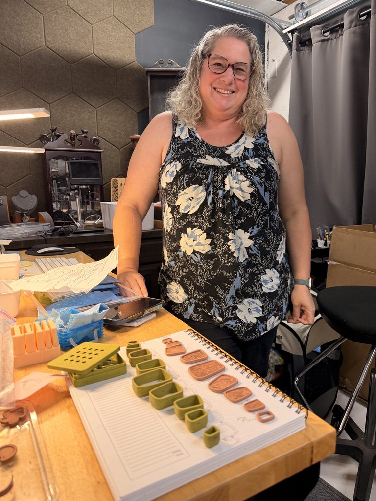 Rachael at the workbench with her bracelet components and cutters.